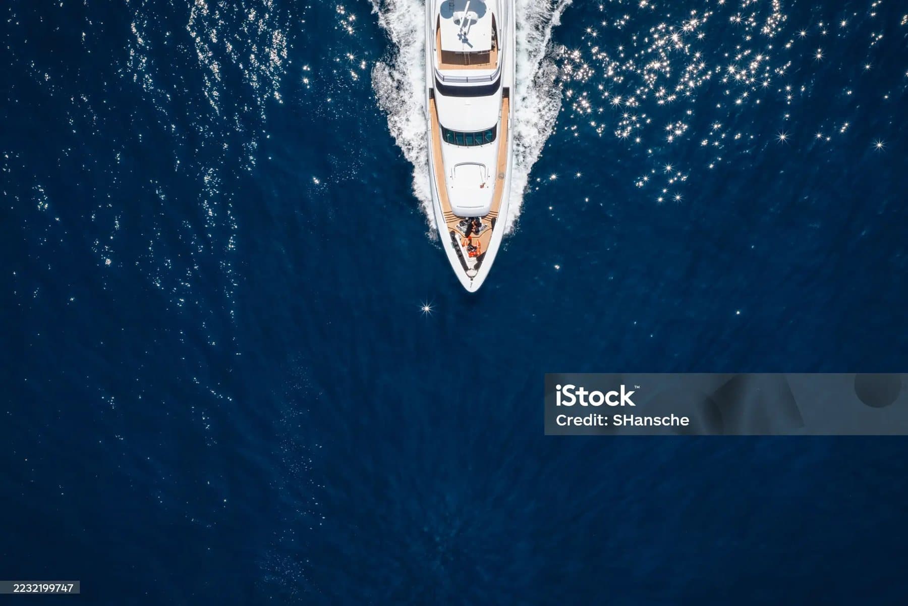 A superyacht cruising on deep blue water